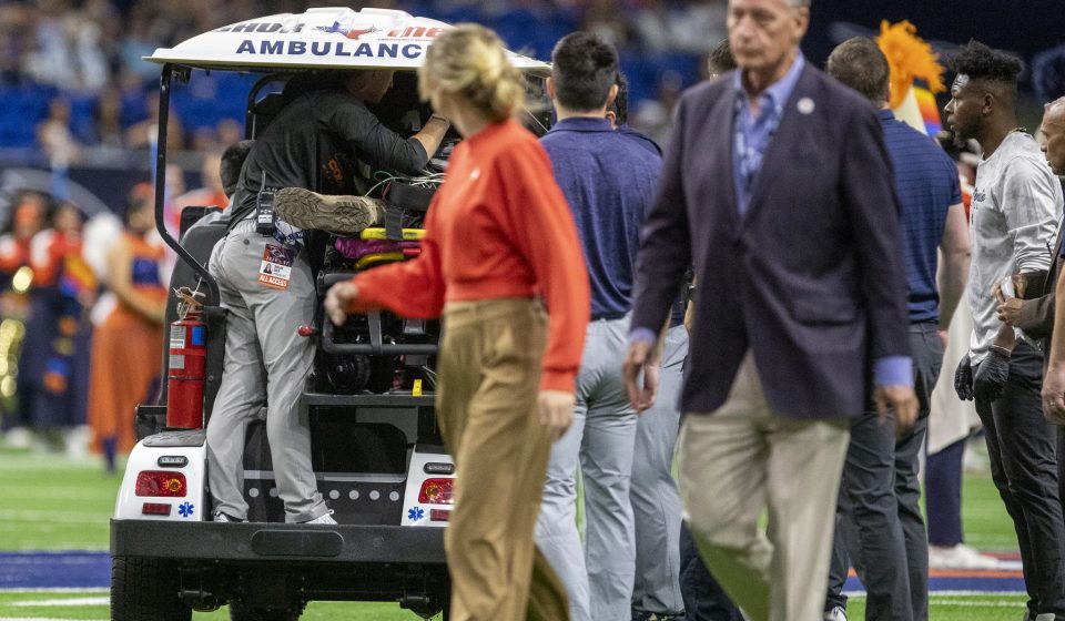 A military officer rappels from the rafters of the Alamodome