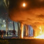 Albanian leader defies calls to resign as student protesters go on rampage in capital