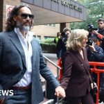 Russell Brand appears in court for rape trial to begin - BBC