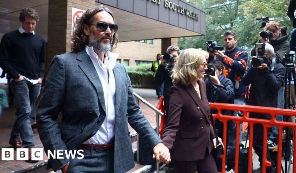 Russell Brand appears in court for rape trial to begin - BBC