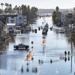 Photos show record high tides flooding homes and roads in Southern California