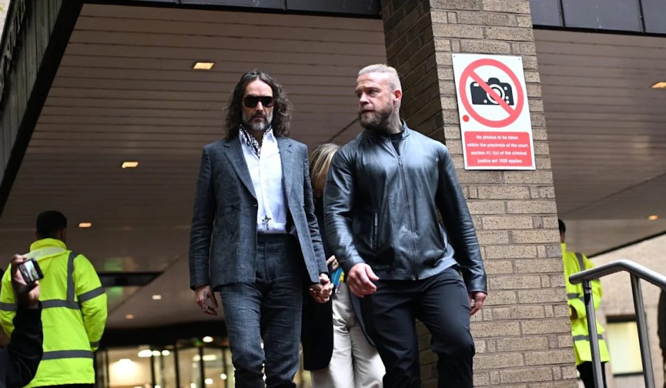 Russell Brand's indecent assault charge reduced by judge: trial continues