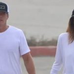 Cindy Crawford and Rande Gerber hold hands during their first public outing together since the death of their son Presley