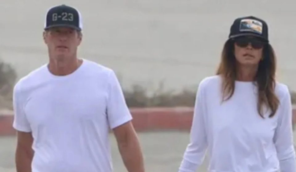 Cindy Crawford and Rande Gerber hold hands during their first public outing together since the death of their son Presley